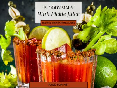 Two glasses containing a Bloody Mary with pickle juice, complete with elaborate garnishes.