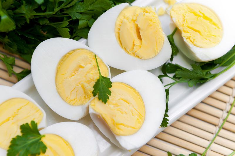 A small number of sliced boiled eggs on a white plate