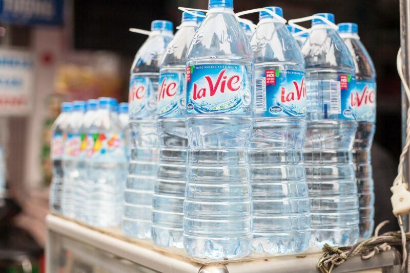 Large and small bottles of filtered water in a Vietnamese grocery store