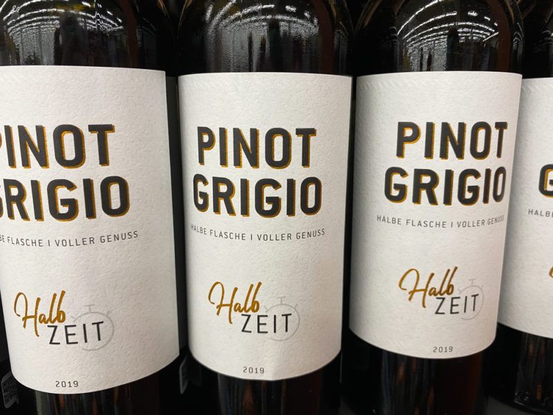 Four bottles of Pinot Grigio wine where the labels can be seen for three of them