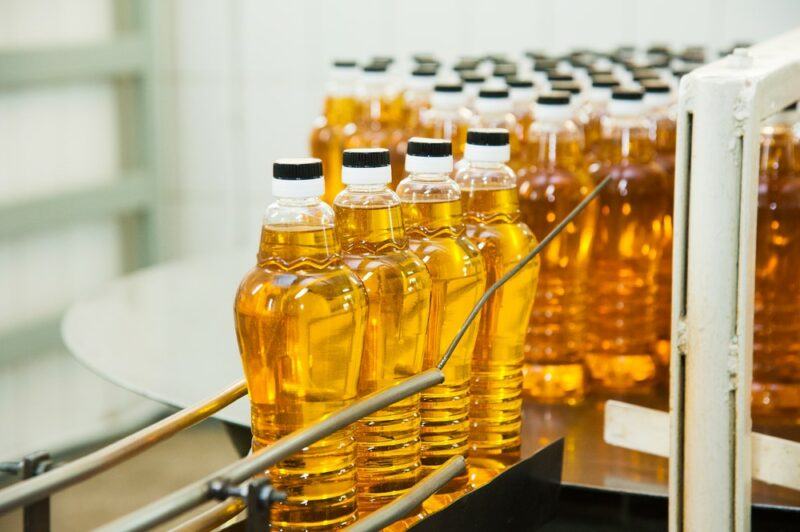 Many bottles of refined oil in a factory