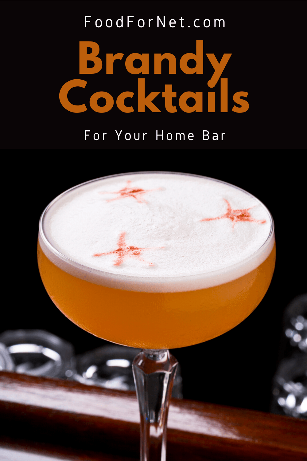 A classic sidecar cocktail on a bar against a black background