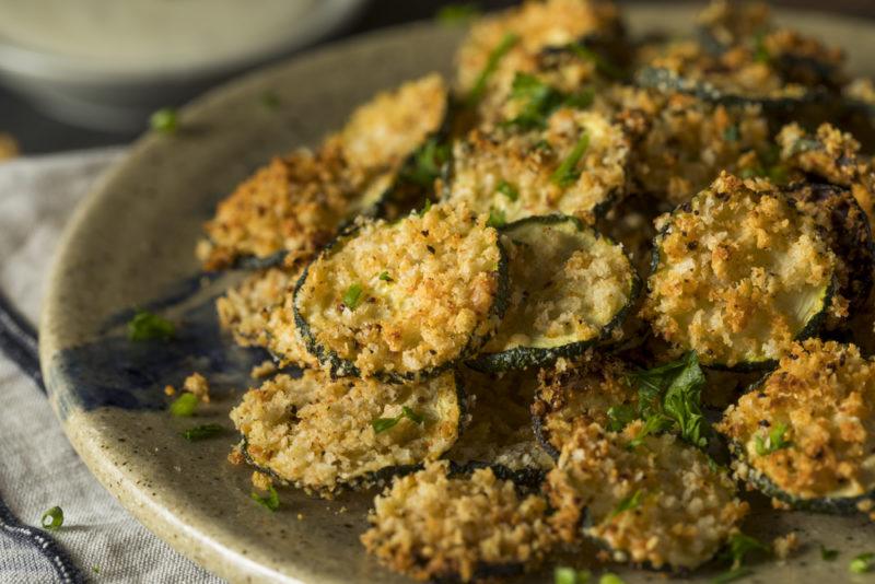 A dark plate with breaded zucchini chips