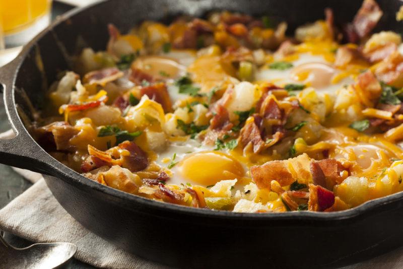 A black cast iron frypan containing breakfast hash