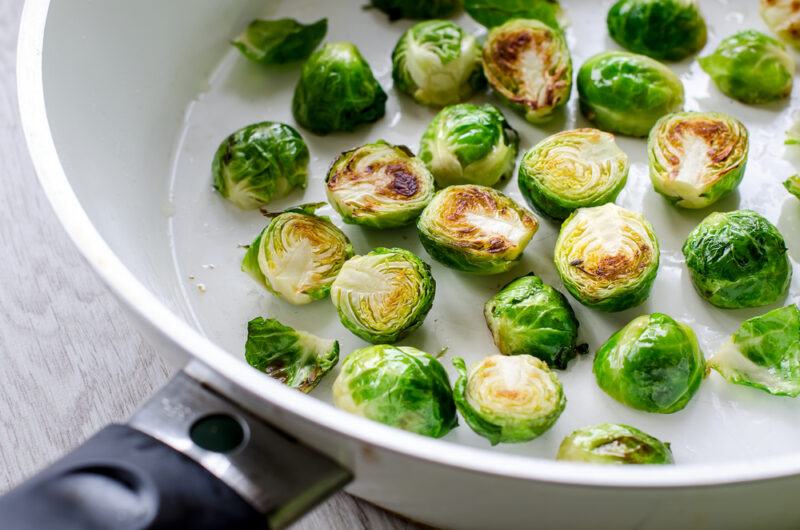 closeup image of a frying pan with Brussels sprouts