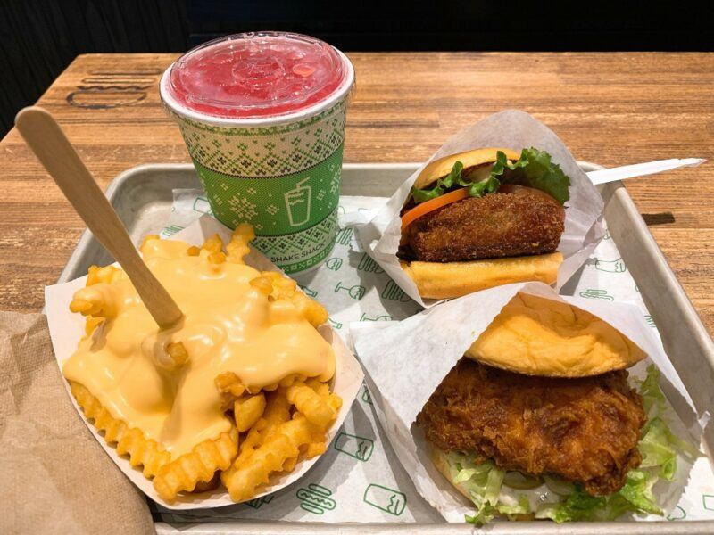 A meal at an airport, including a burger, fries, and a drink