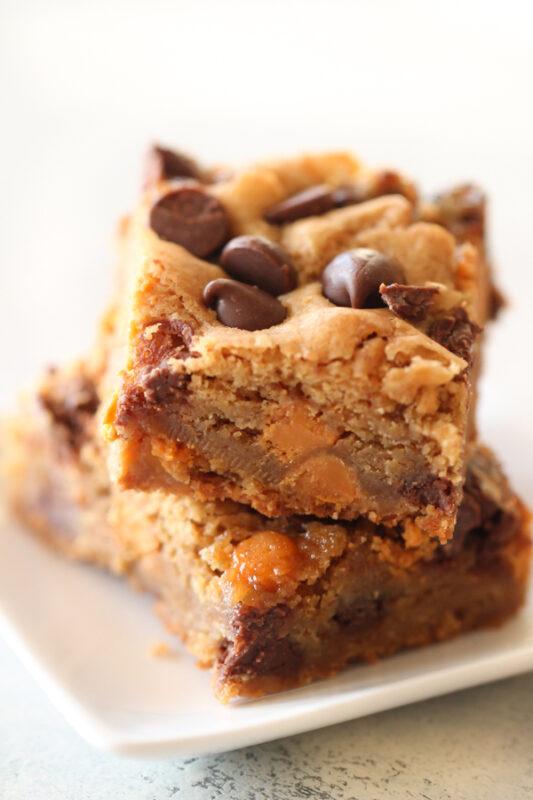 A white plate with two large butterscotch chocolate chip blondies