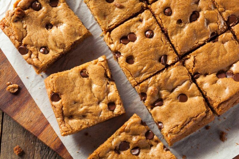 A baking sheet with cake mix cookie bars that have been cut into squares