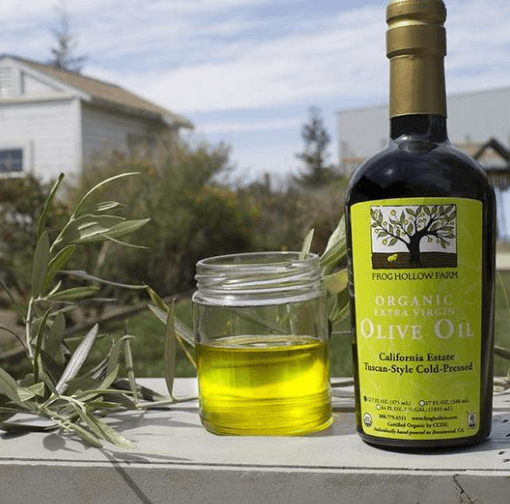 California’s Finest Olive Oil Club | Food For Net A bottle of olive oil and a glass on a table