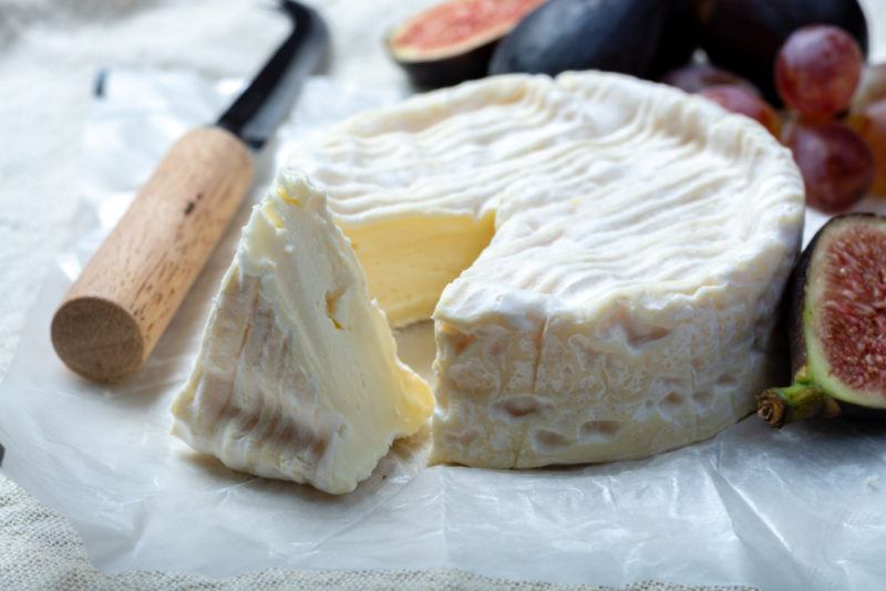 Camebert Cheese on a white plate with figs