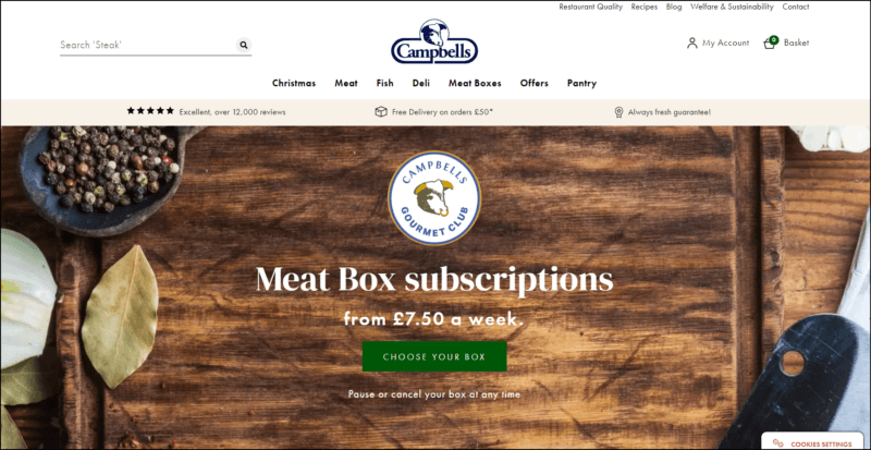 screenshot of Campbells Meat Box Subscriptions' web page, the white header bears the website's name/logo along with the main navigation menu, main content area has a brown wooden background with text overlay about the meat subscription