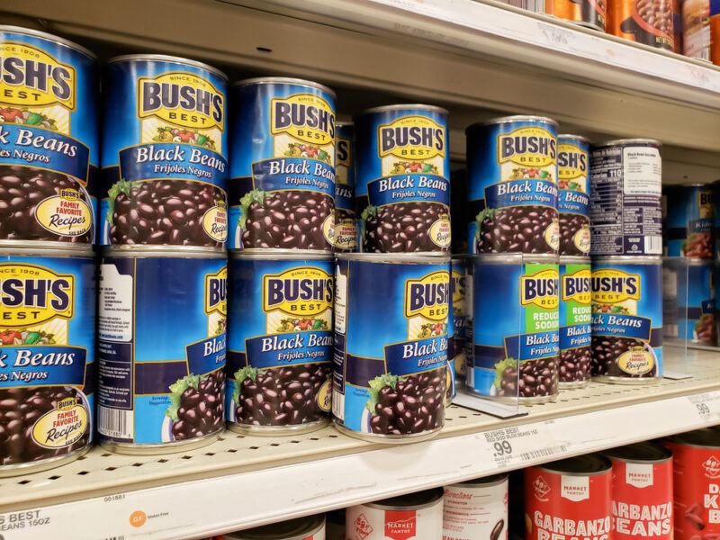 Cans of Bush's black beans in a grocery store