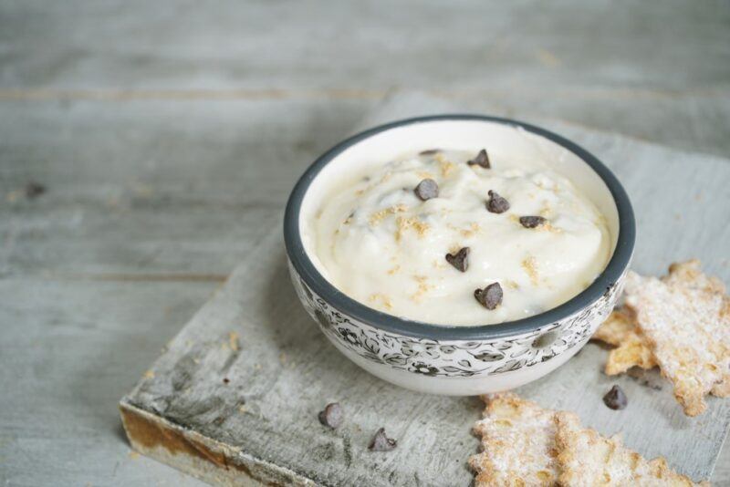 A black and white bowl containing cannoli dip