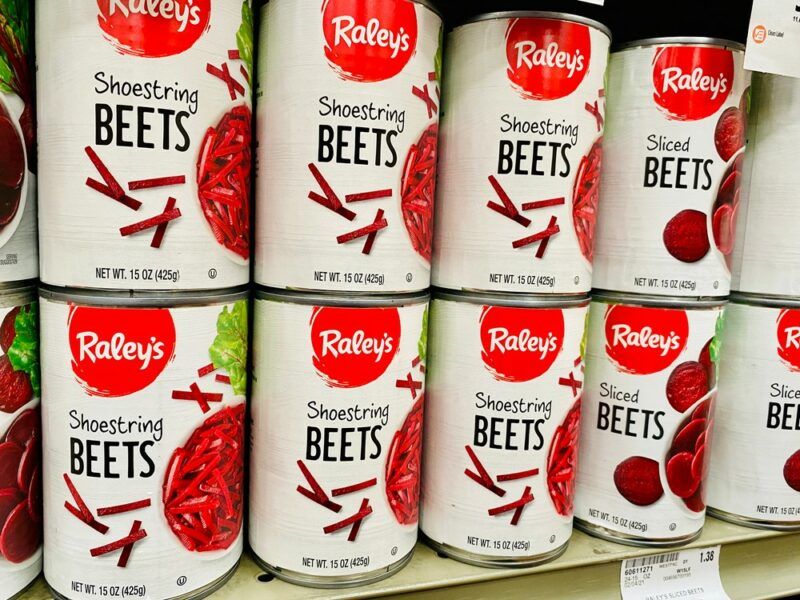 Cans of shredded beets on a grocery store shelf