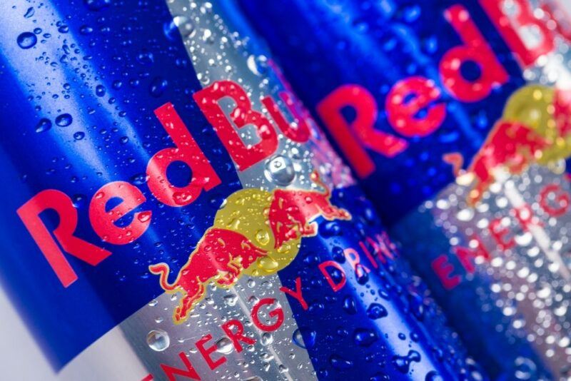 A close up image of Red Bull cans with water droplets