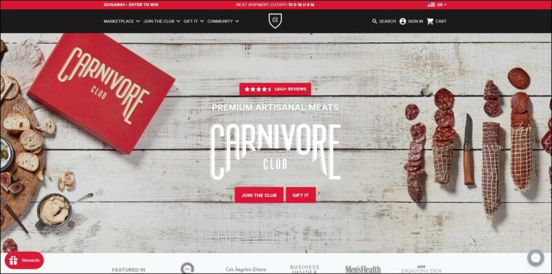 screenshot of Carnivore Club's web page, the page contains a red announcement bar on top followed by a black banner containing the company's logo alongside the main menu, the page displays a big picture banner showing an overhead shot of the club's box and different cure meats, with text overlay.