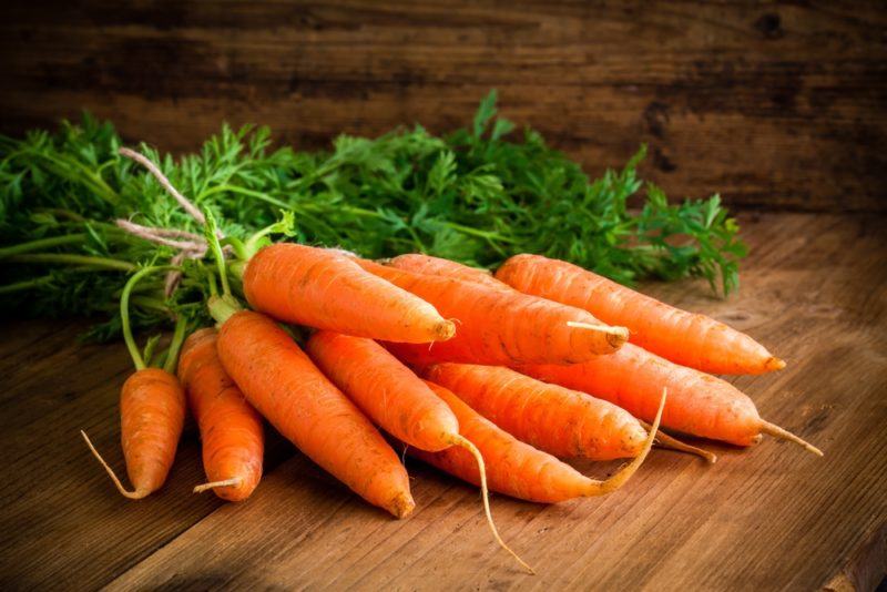 Fresh carrots on a wooden floor