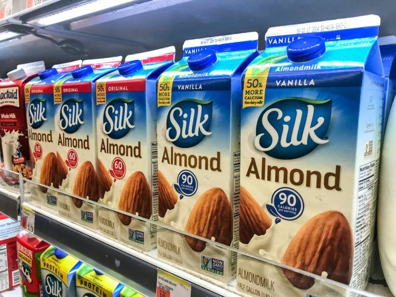 Boxes of Silk almond milk on a grocery store shelf