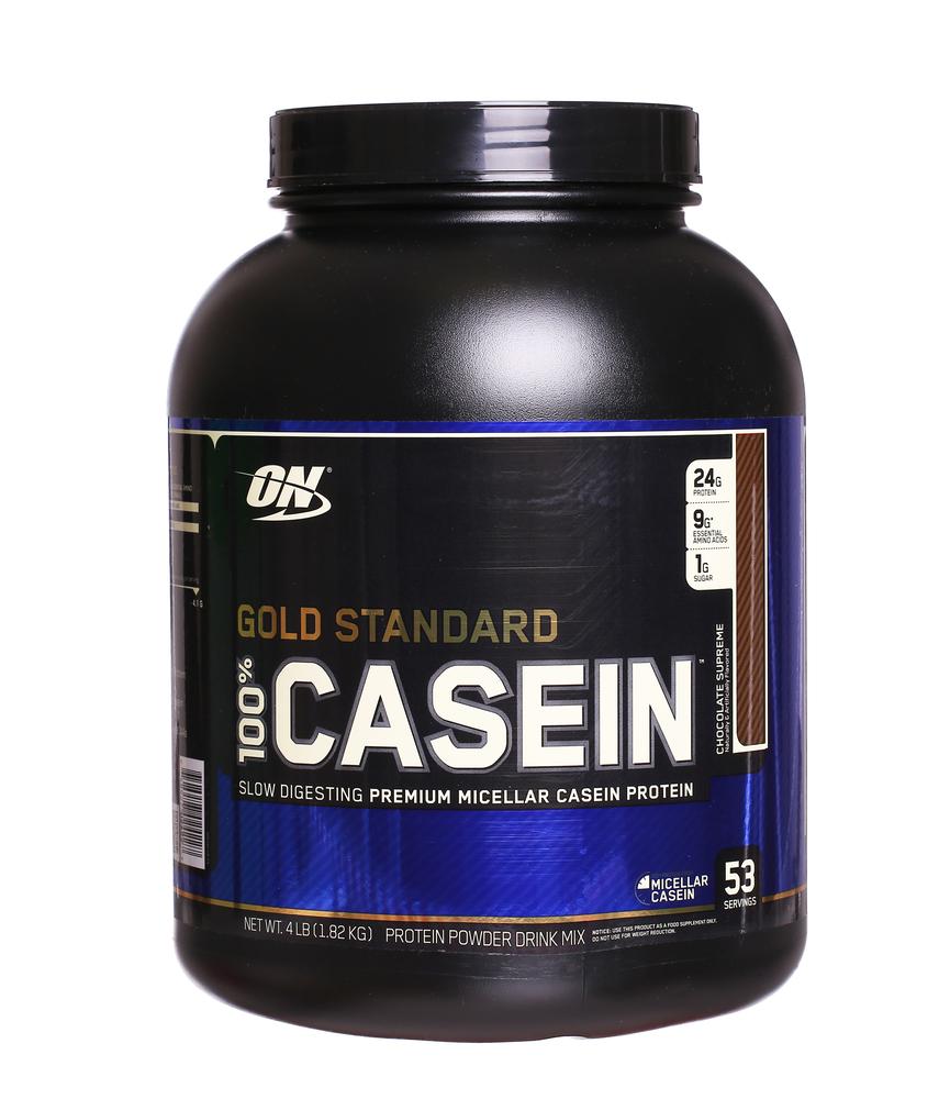 A black tub of Gold Standard casein powder