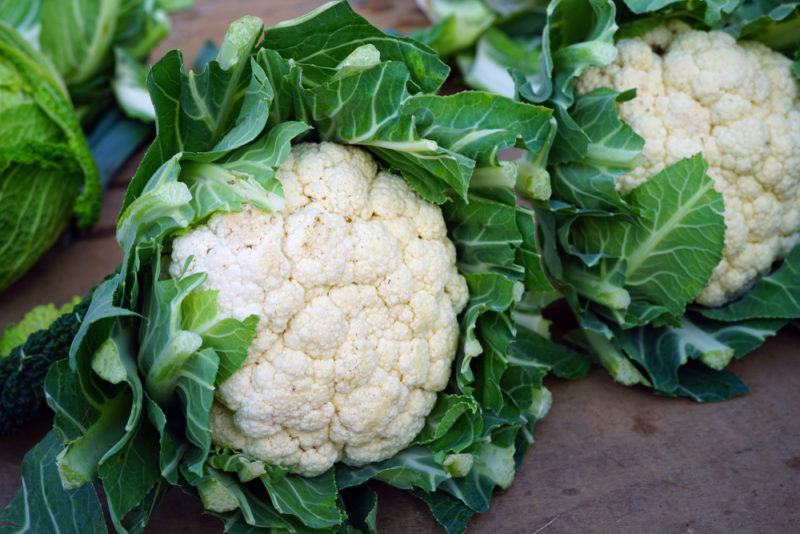 Two cauliflowers on a table