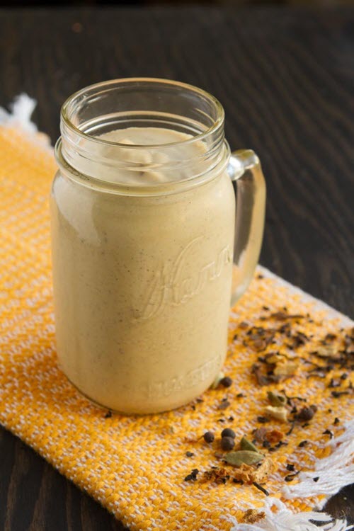 A pumpkin smoothie in a mason jar glass