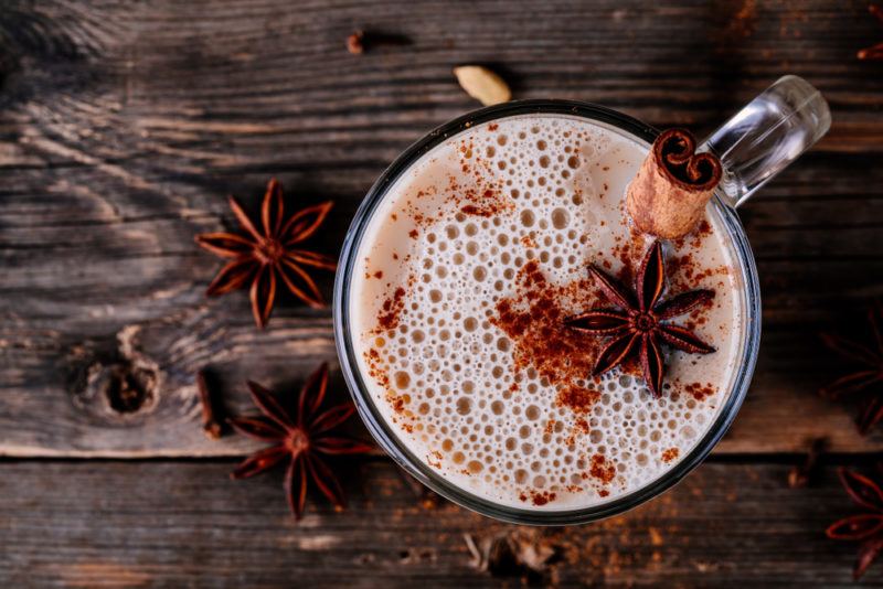 A top down image of chai tea with the spices on the table