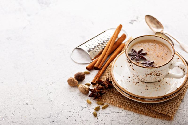 A mug containing chai tea on a white background