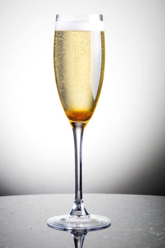 A Champagne Cocktail isolated against a white background