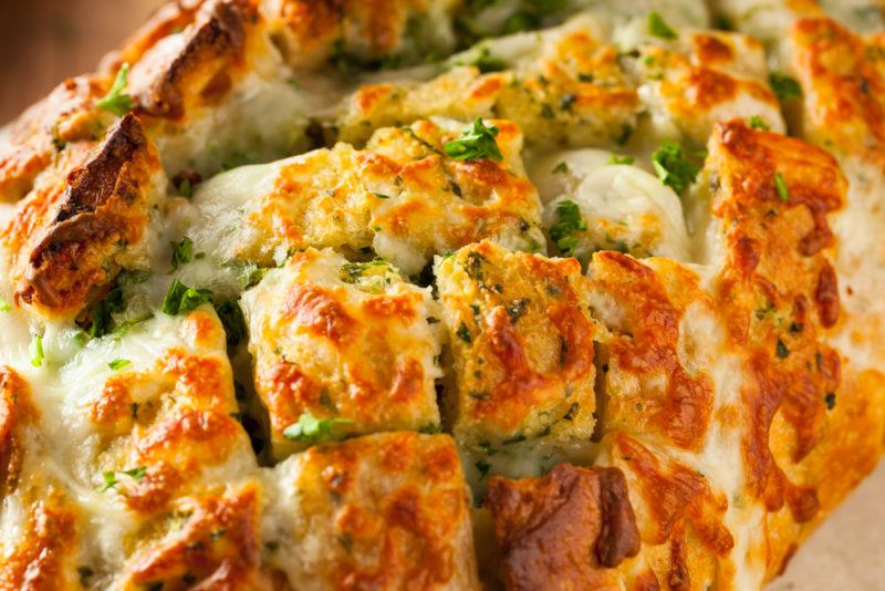 Cheese and herb pull apart bread that's been made by slicing already cooked bread