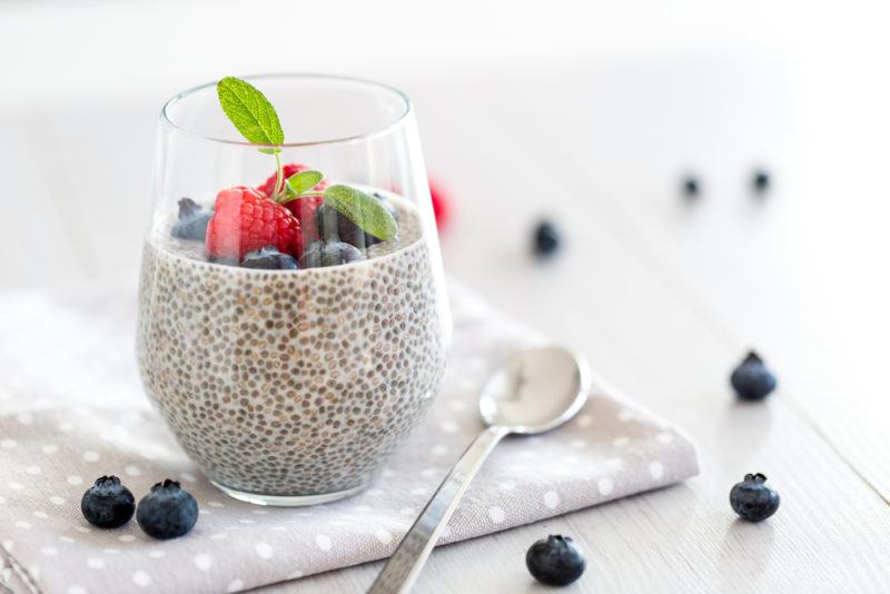 A glass with chia pudding and berries