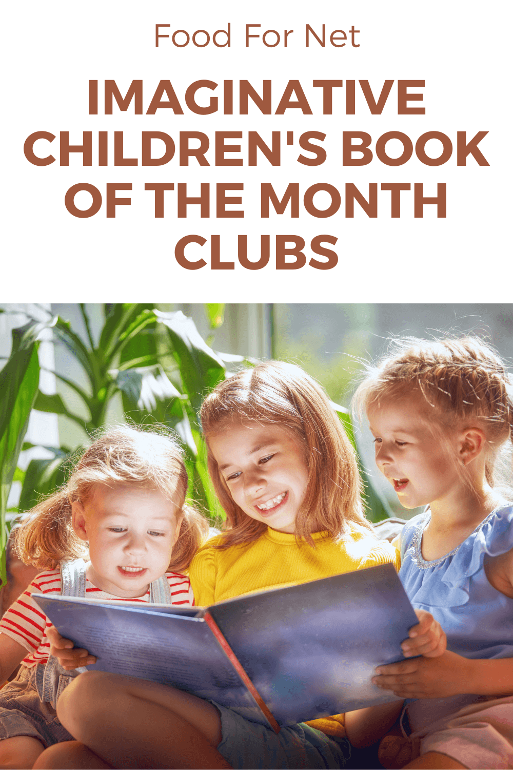 Three young girls reading a picture book and smiling