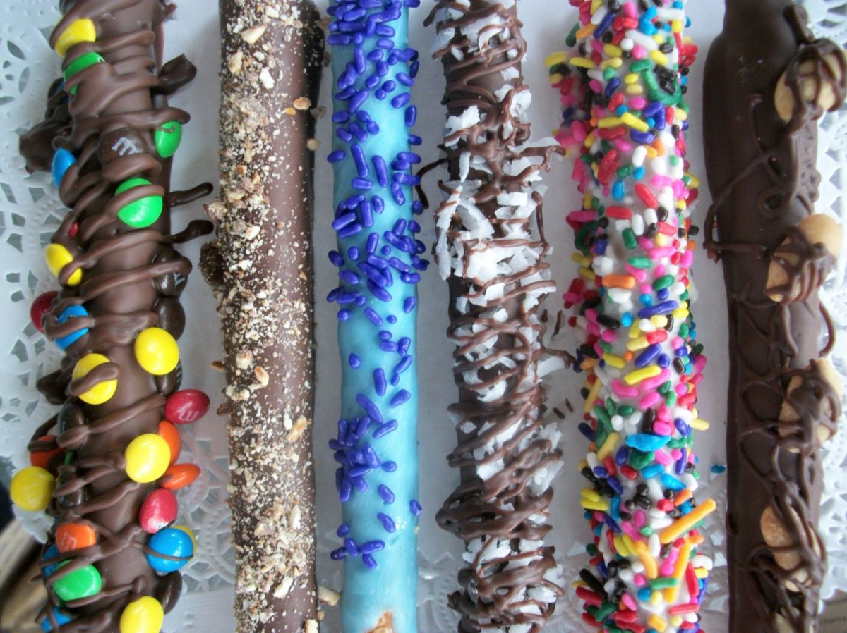 6 hand-dipped chocolate covered pretzel rods with a variety of toppings including m&ms, toffee, Blue sprinkles, coconut, birthday sprinkles, and peanuts