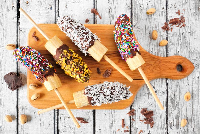 Bananas that have been dipped in chocolate and sprinkles