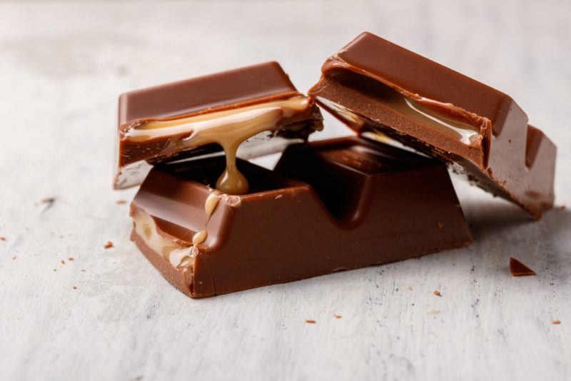 Milk chocolate with caramel on a light colored table