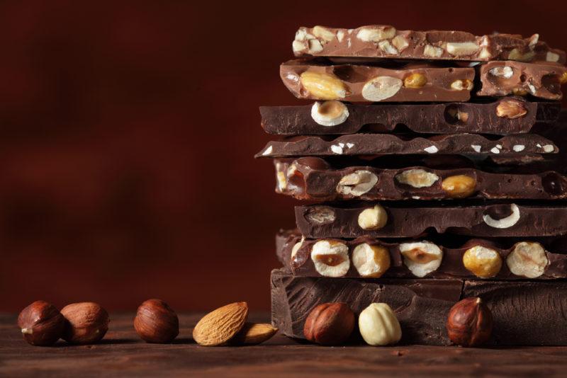 A stack of chocolate pieces with nuts embedded in them