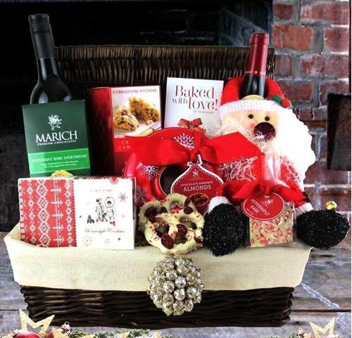 Christmas Cheer Picnic Basket | Food For Net Large wicker basket containing various Christmas items and two bottles of wine