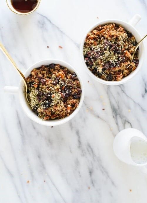 Two small bowls containing cinnamon toast breakfast quinoa on a marble table