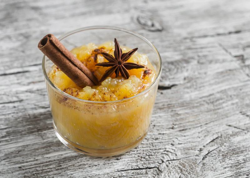 A glass jar with stewed apples, cinnamon and star anise