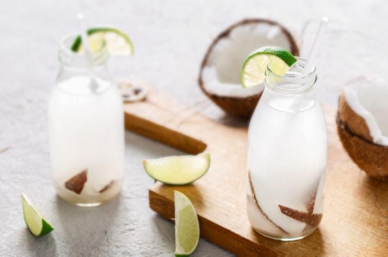 Two glasses with coconut water and chunks of coconut