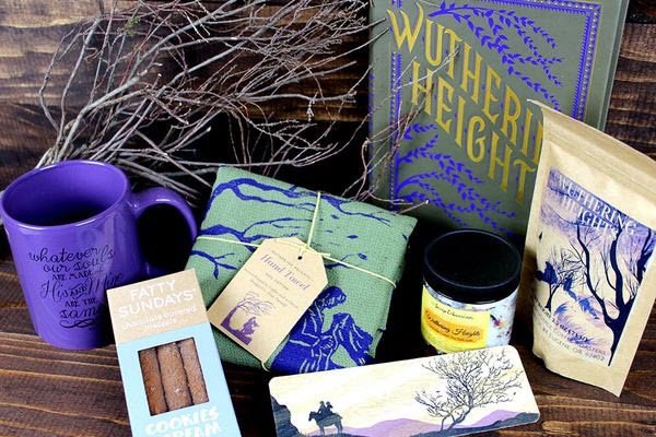 A purple themed box with a book, tea, mug and more