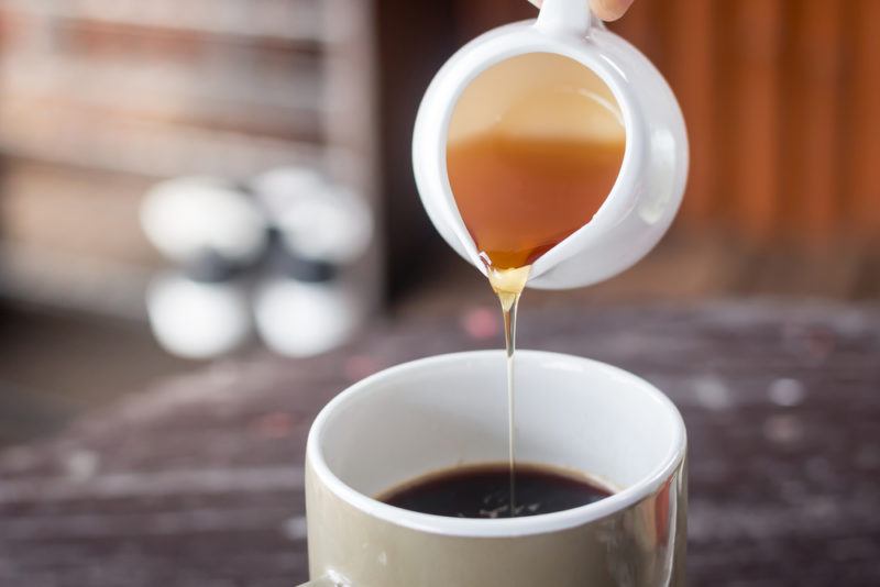 Honey being poured into coffee