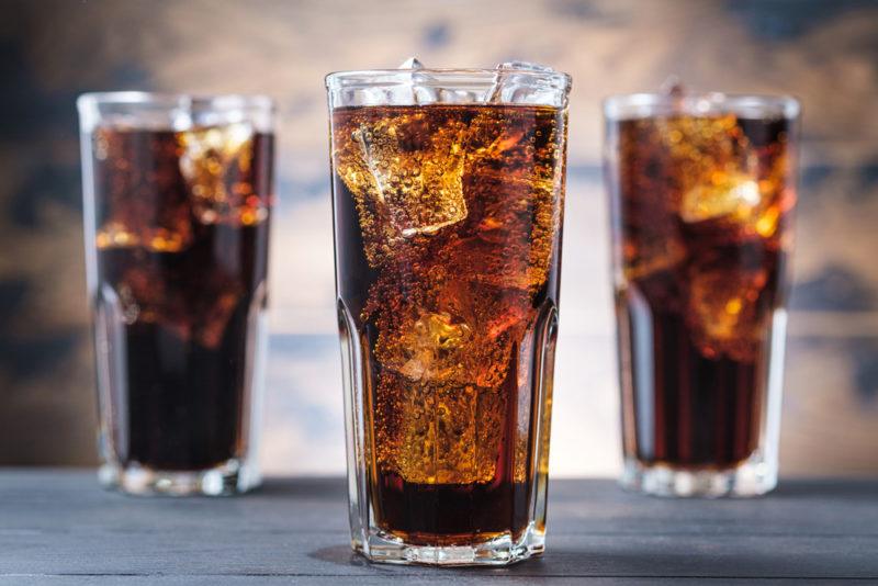 Three glasses of cola and ice