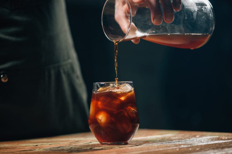 Cold brew coffee being poured into a glass