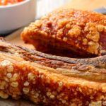 Pieces of Colombian style pork belly on a wooden board