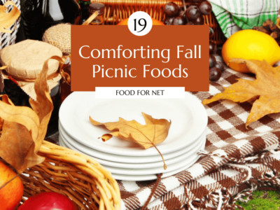 A fall picnic, complete with a picnic blanket, plate, apples, and a leaf