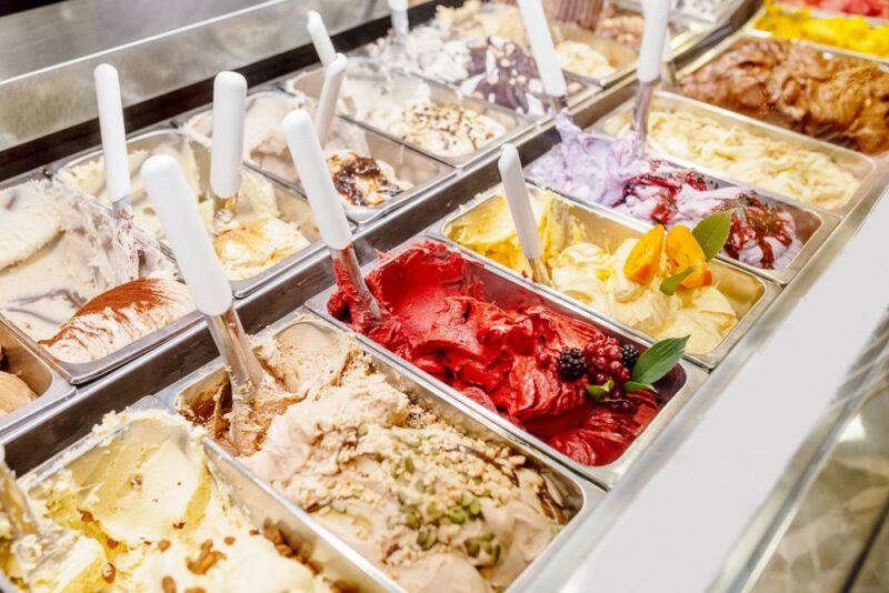 Tubs of gelato and sorbet with spoons in an Italian store