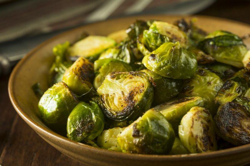 A brown plate filled with cooked Brussels sprouts