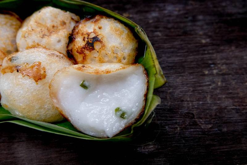 A bamboo or banana leaf containing cooked khanom krok