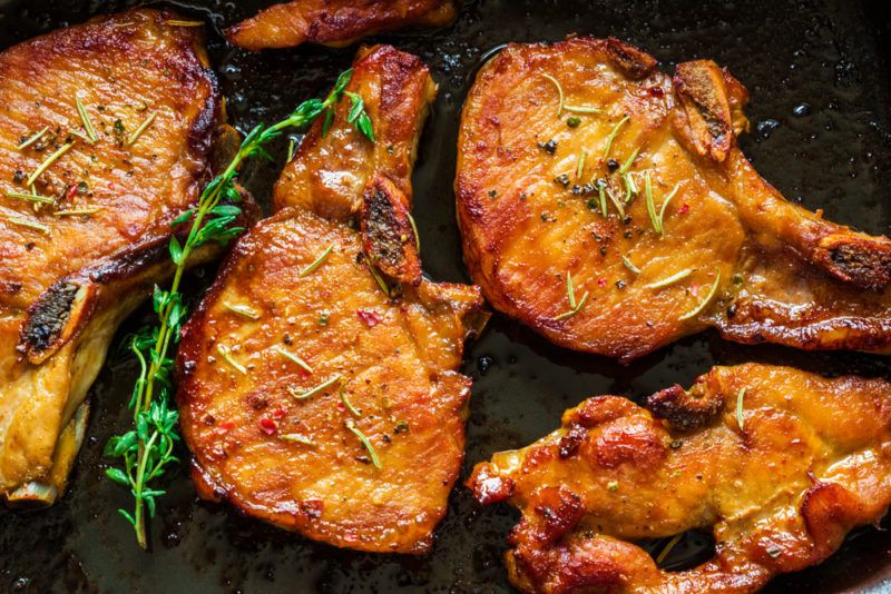 Cooked lean pork chops in a fry pan or cooking dray