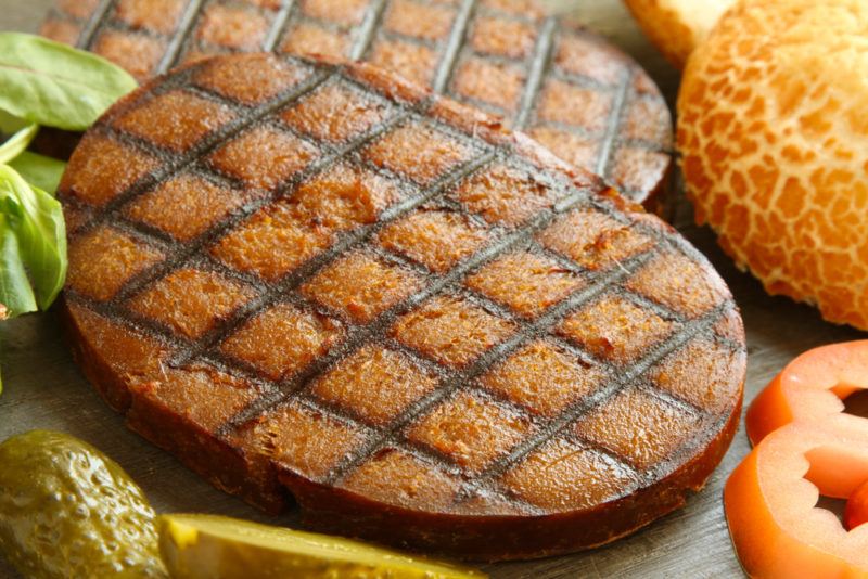 Two steaks of cooked seitan, ready to be used to create hamburgers